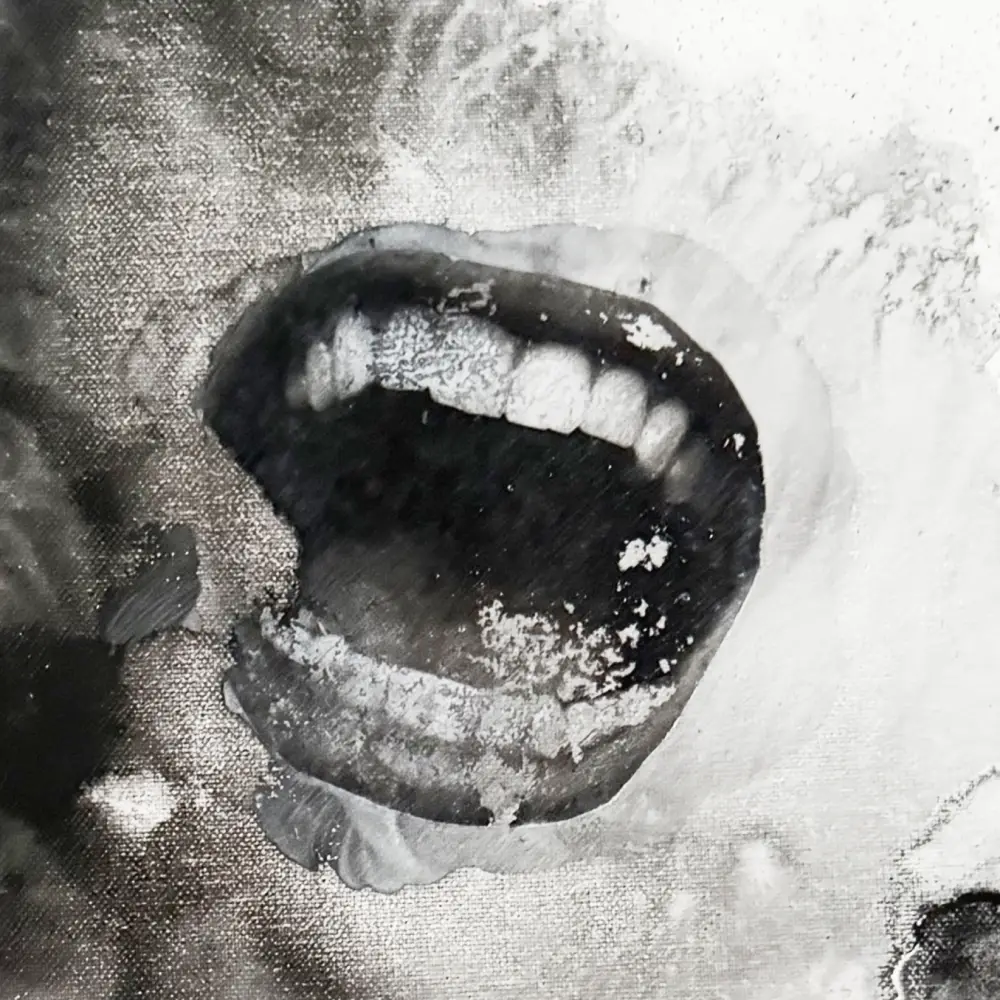 An open mouth, rendered in torn and degraded photographic texture